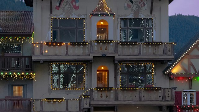 A Bavarian-style building in Leavenworth lit with Christmas lights at dusk