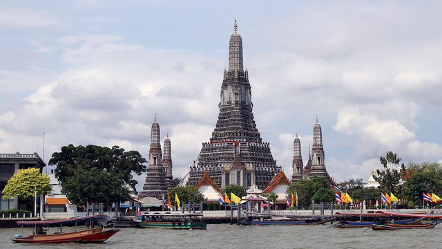 Wat Arun's central prang seen across the Chao Phraya River in Bangkok